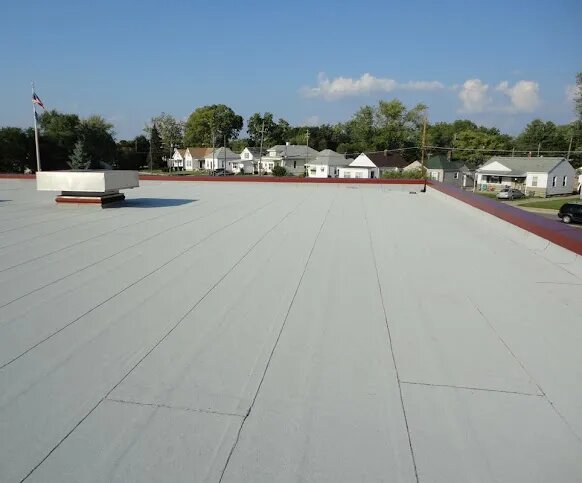 Commercial flat roof after GoNano elastomeric membrane treatment showing seamless protective coating
