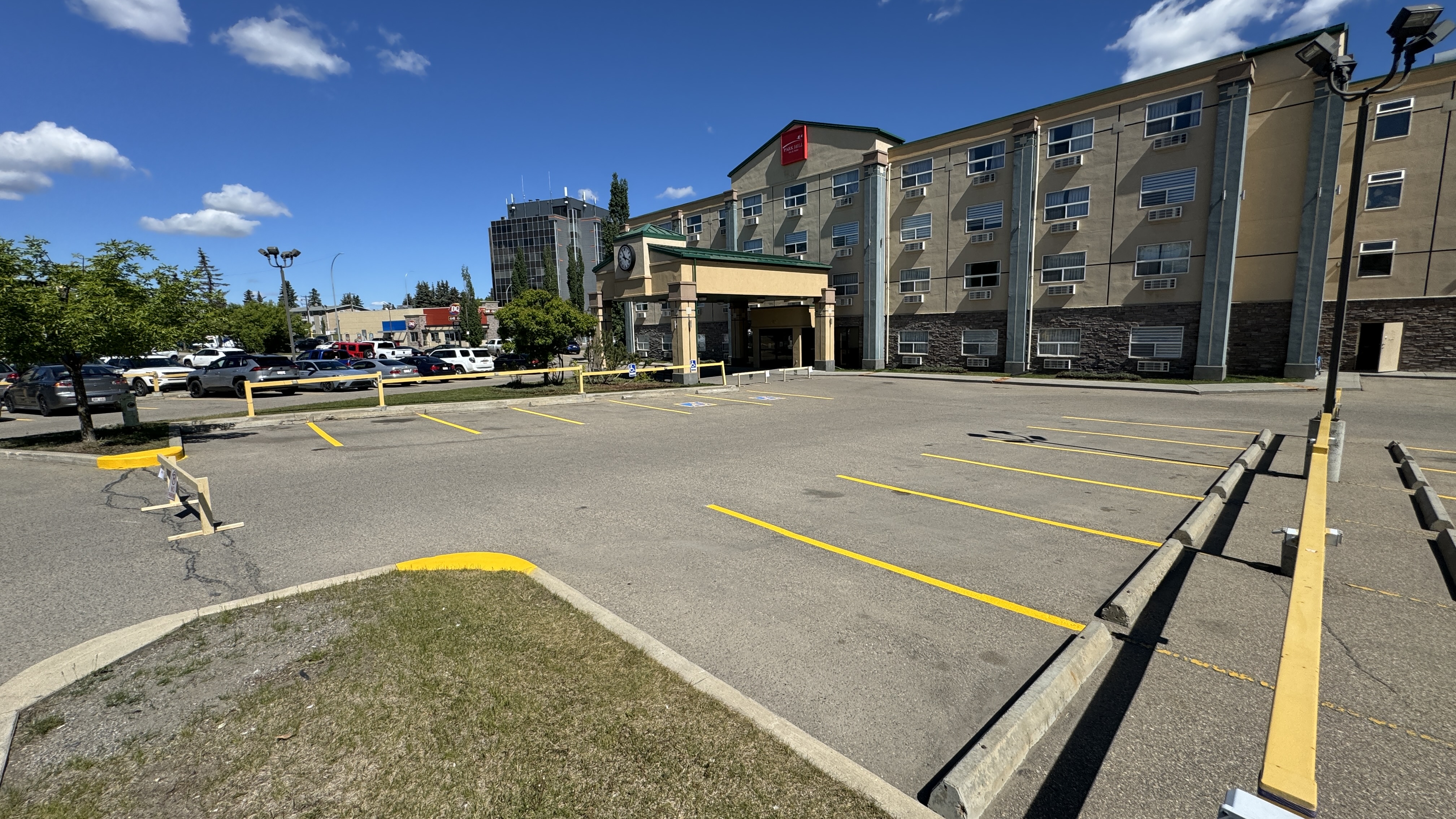 Hotel parking lot line painting with fresh yellow markings — Red Deer, AB